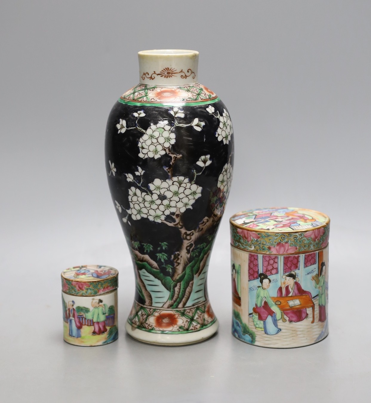 A Chinese famille noire vase, and two famille rose lidded pots, 19th century, Vase 12 cms high.